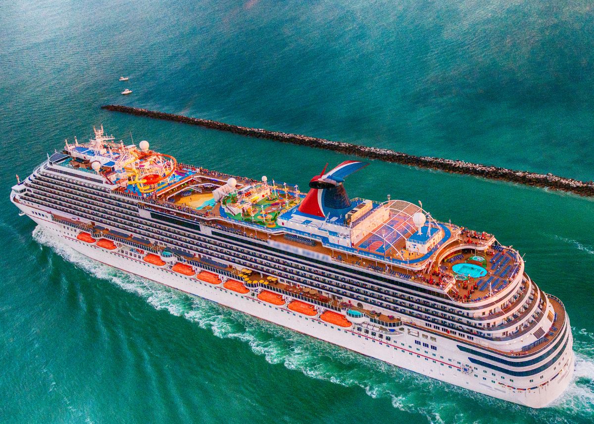 A carnival cruise ship on the open water.