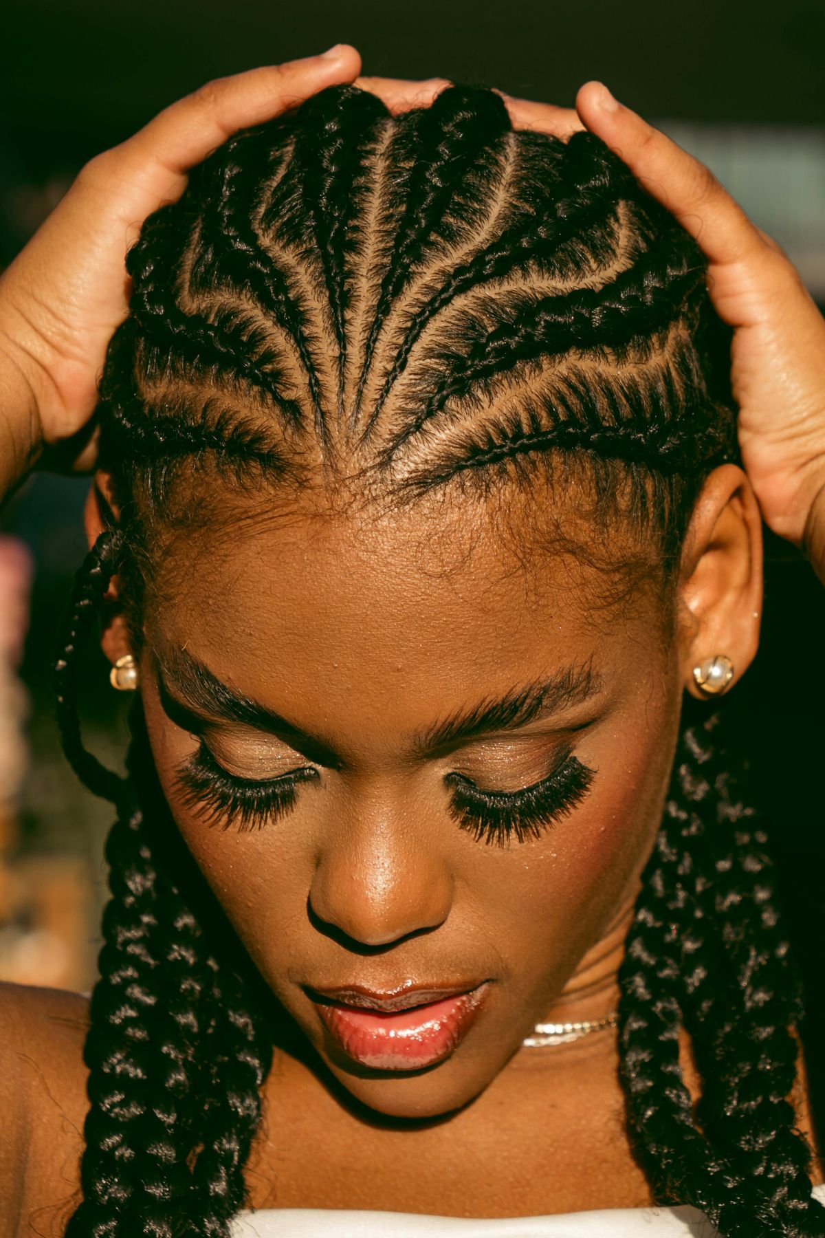 A black woman with cornrows styled hair.