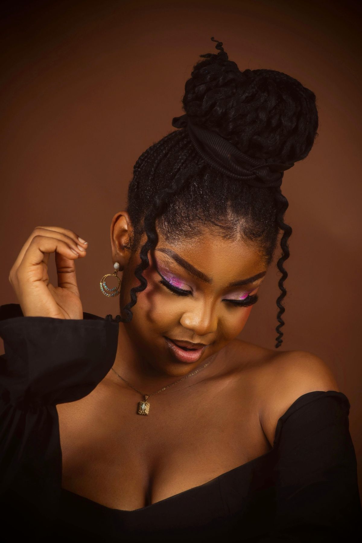 A black woman with a high bun.