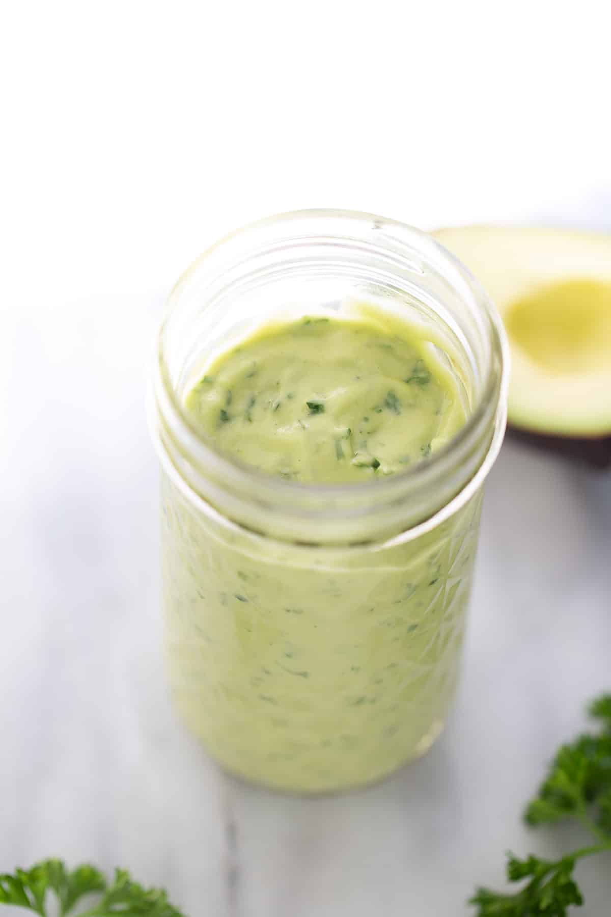 Green goddess dressing in a mason glass jar.