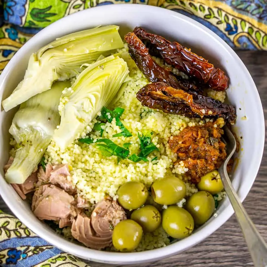 Mediterranean tuna mal prep bowl with artichokes, olives, and sun-dried tomatoes.
