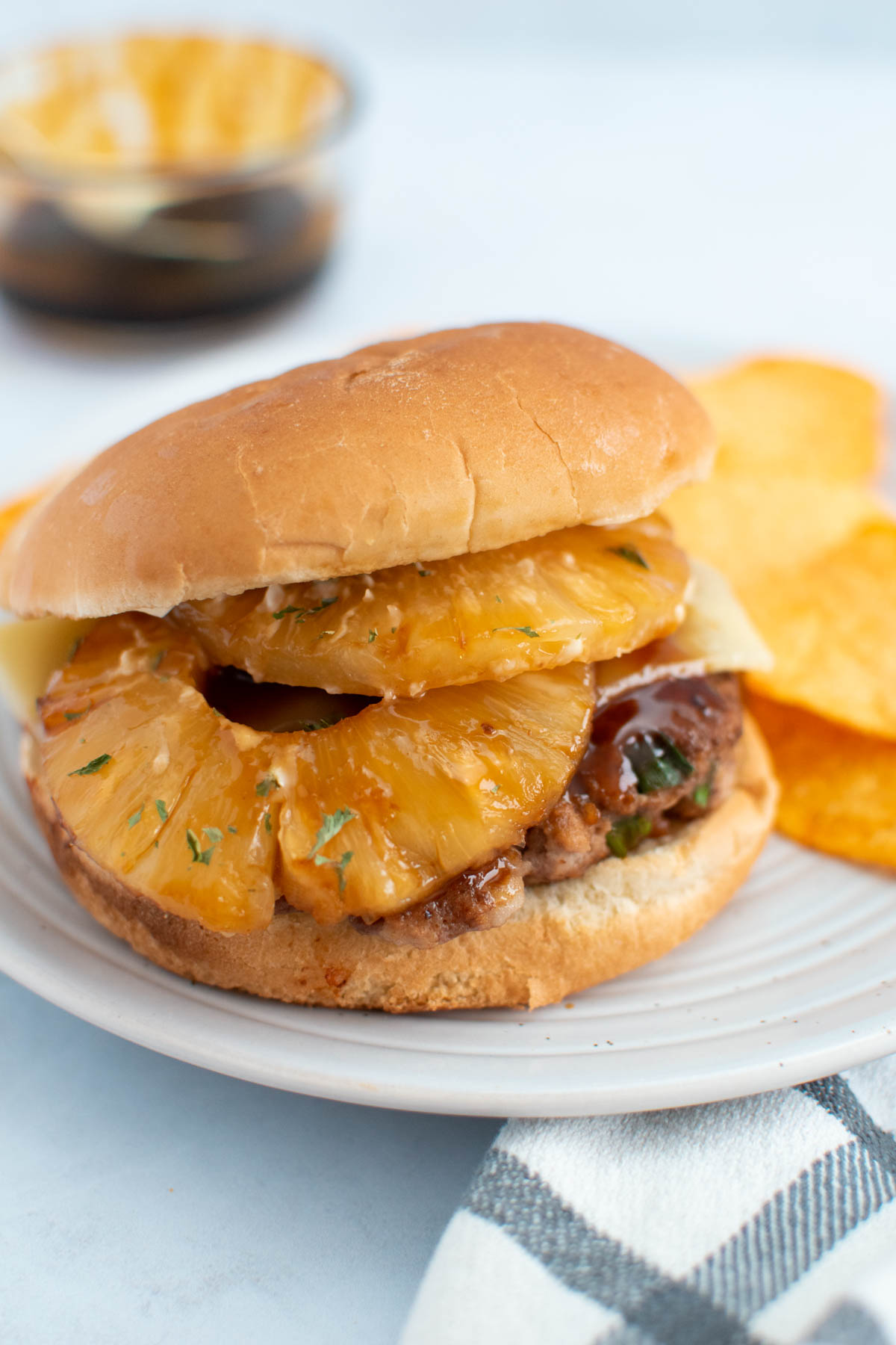 Teriyaki turkey burger with sliced pineapple.