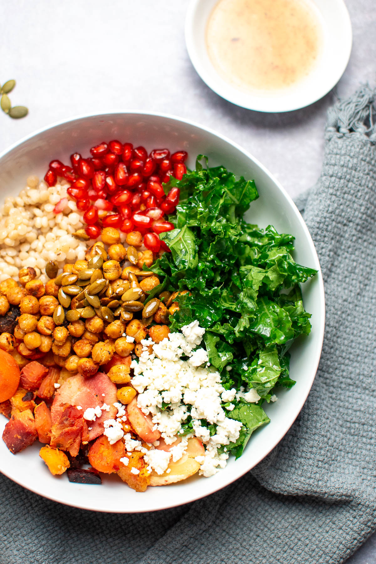 Chickpea harvest bowl with kale and pomegranate seeds.