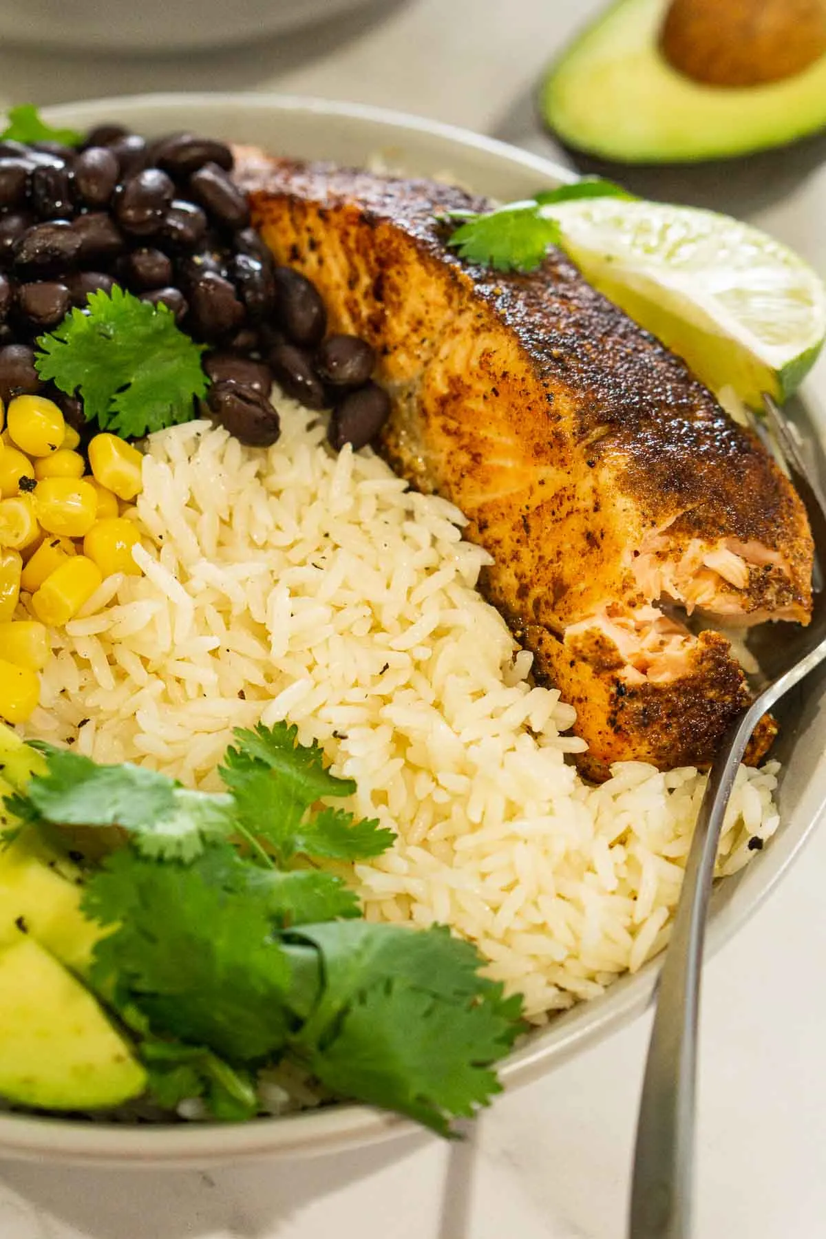 Salmon meal prep bowl with rice, corn, and black beans.