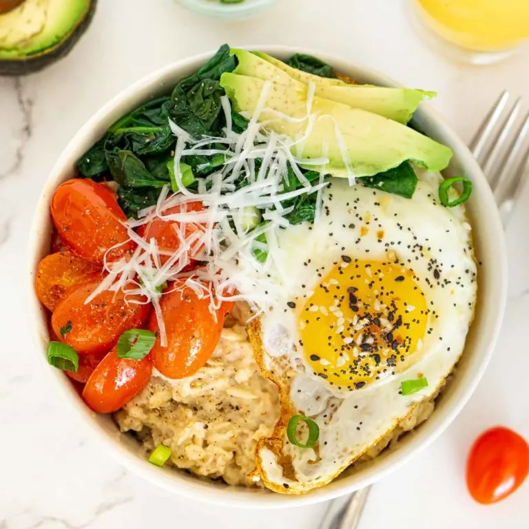 Savory oatmeal bowl with fried egg and veggies.