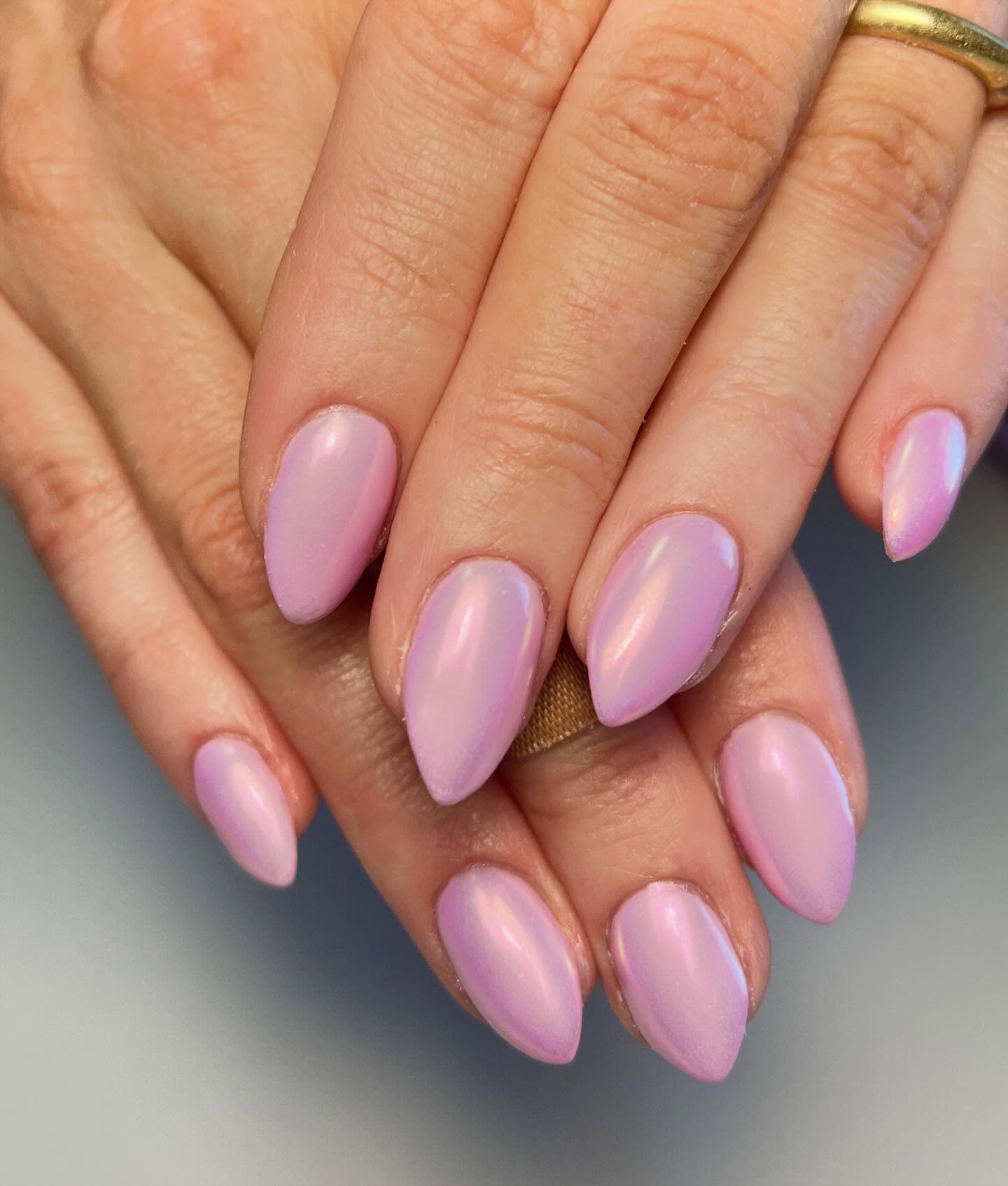 Pink chrome stiletto nails.
