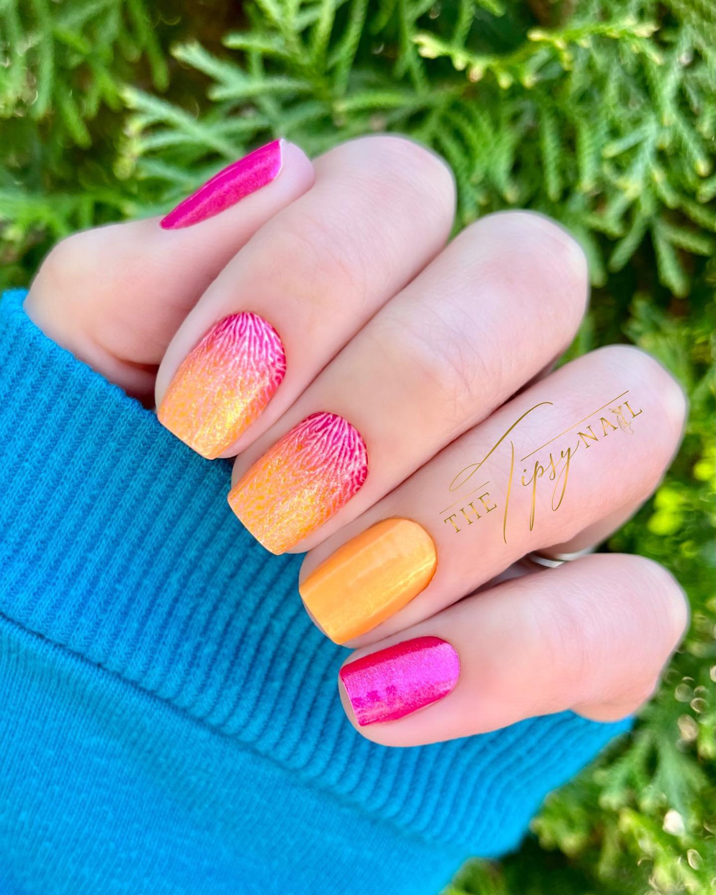 Pink and orange ombre glitter nails.