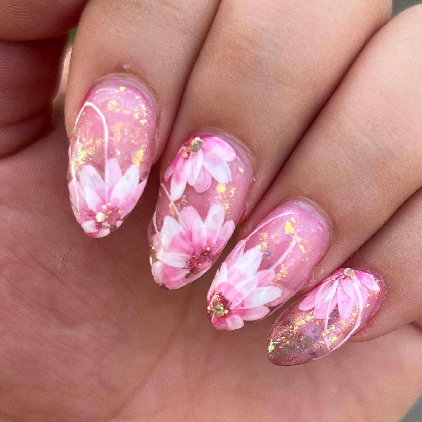 Marble, glitter pink nails with pink-white flowers.