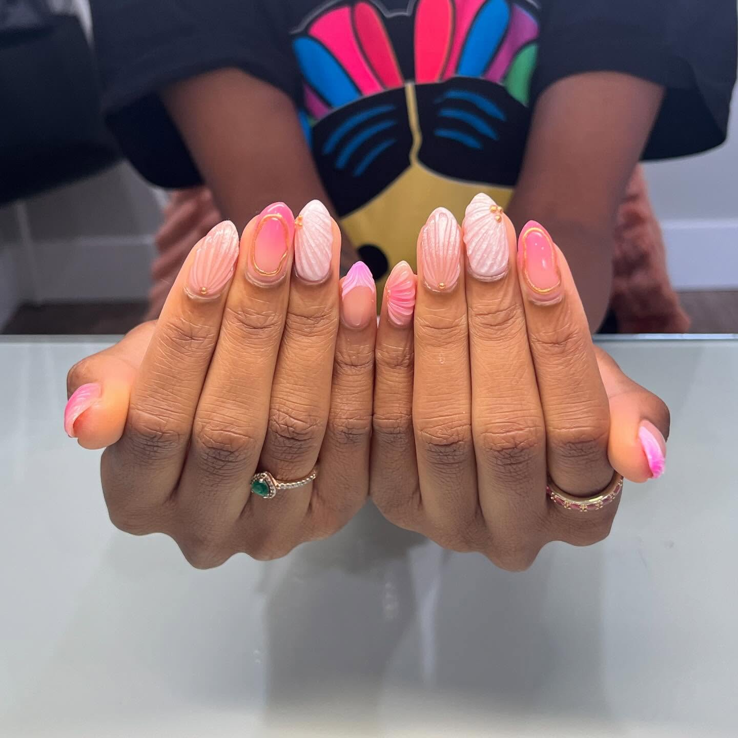 Pink and white ombre nails with raised 3D nail art.