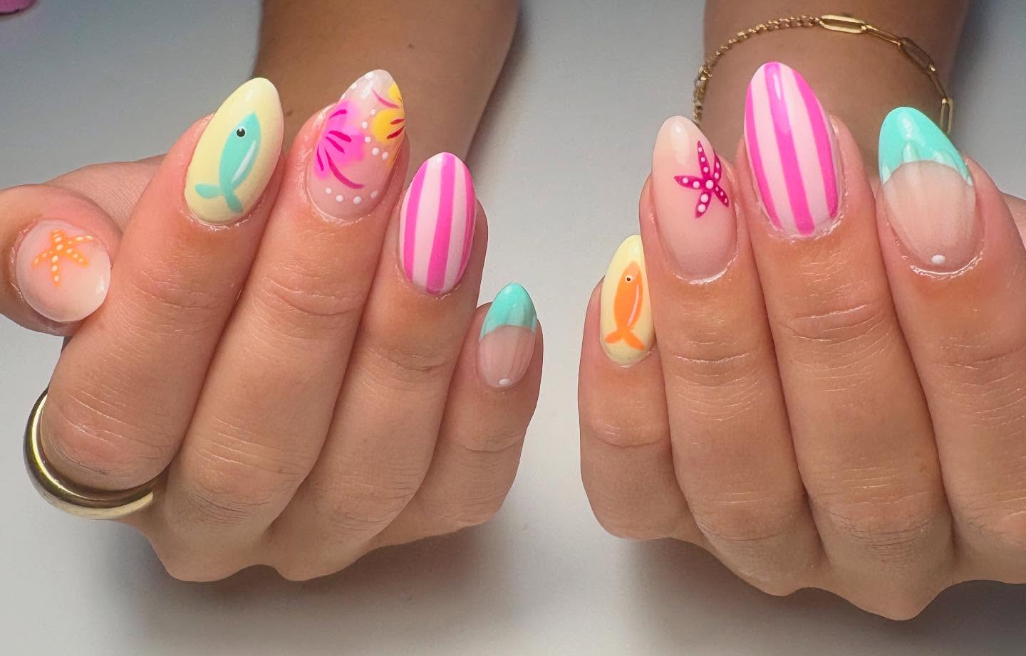 Beach nails with fish, pink stripes, and palm trees.