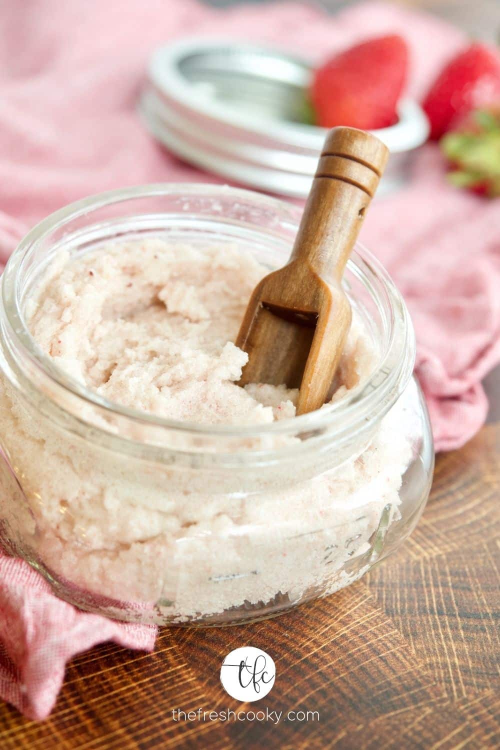 Homemade whipped strawberry sugar scrub in a mason jar.