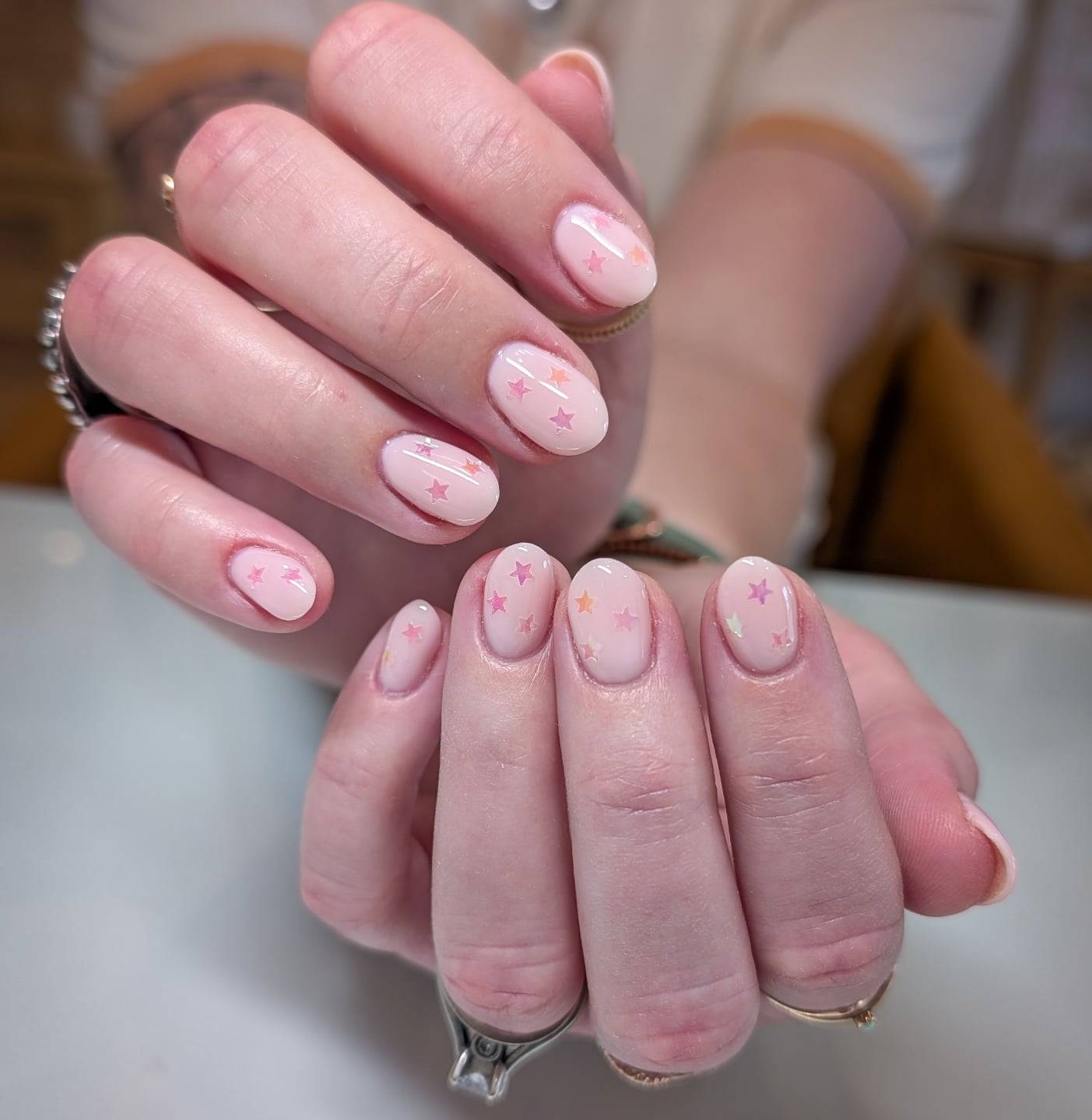 Nude nails with shimmery mini stars.
