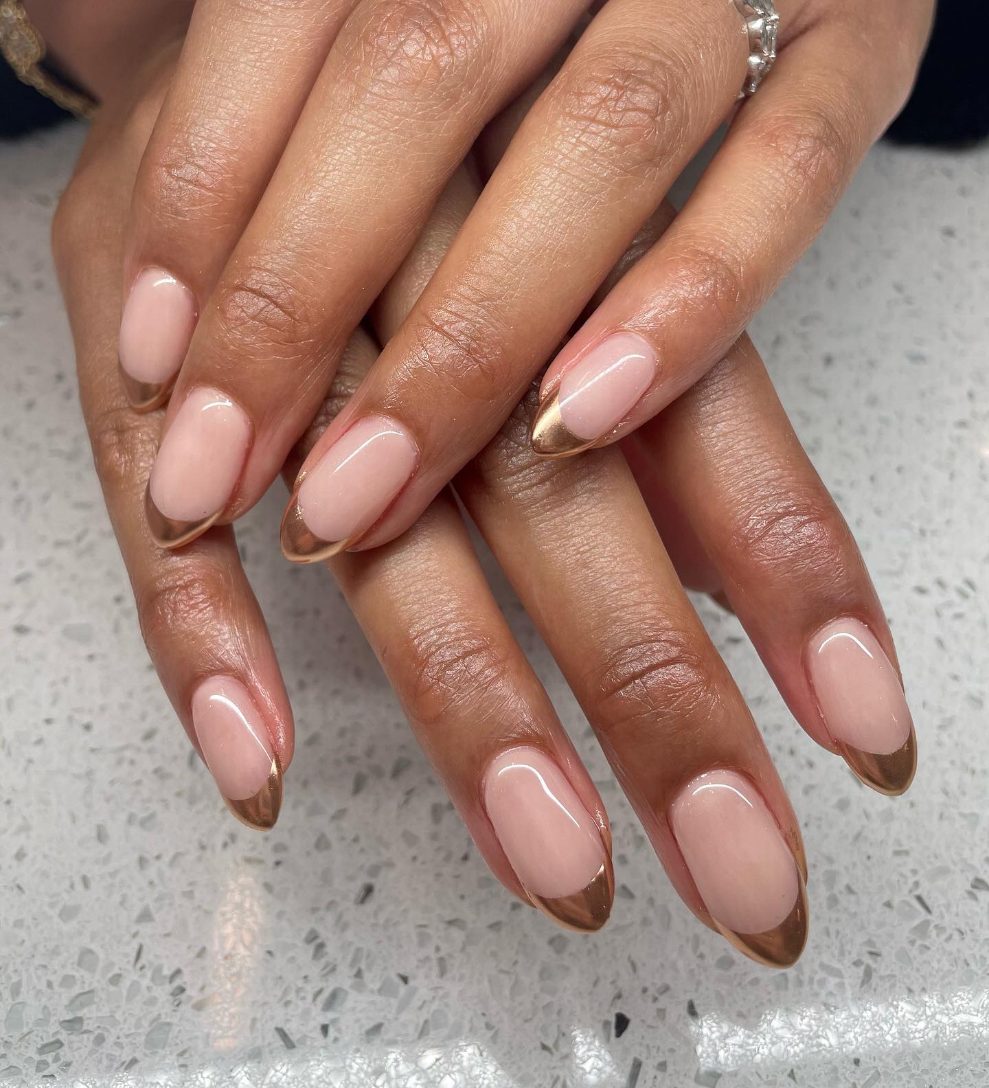 Almond French tip nails with shimmery copper tips.