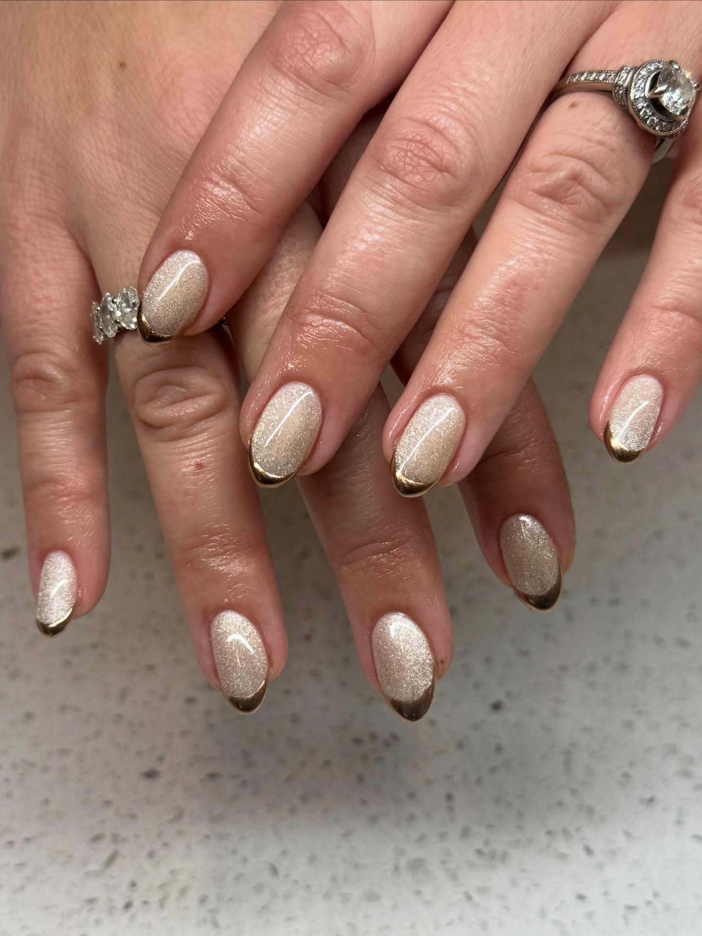 Shimmery pale gold nails with gold French tips.