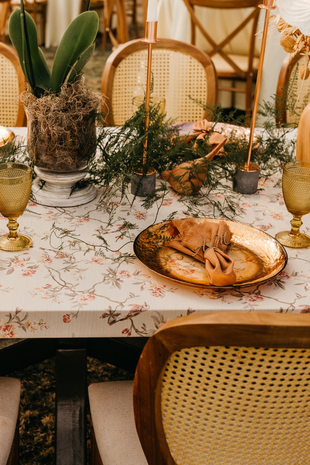 Copper plate with rust napkin and silverware on an Easter table.