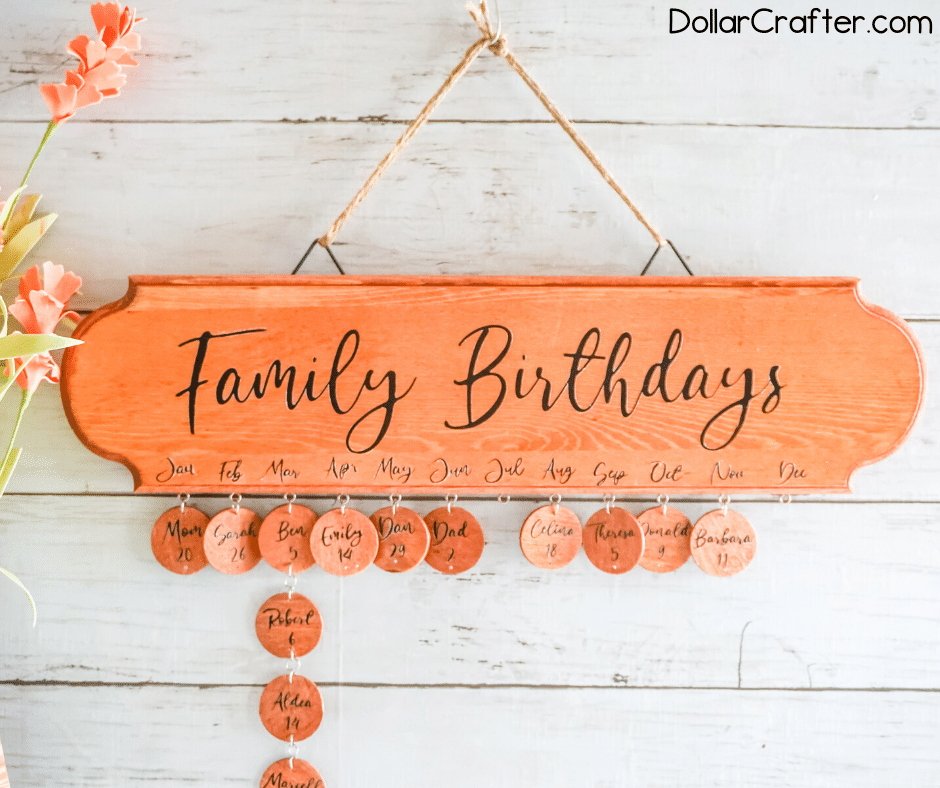 DIY family birthday board craft hanging on a white wood slat wall.