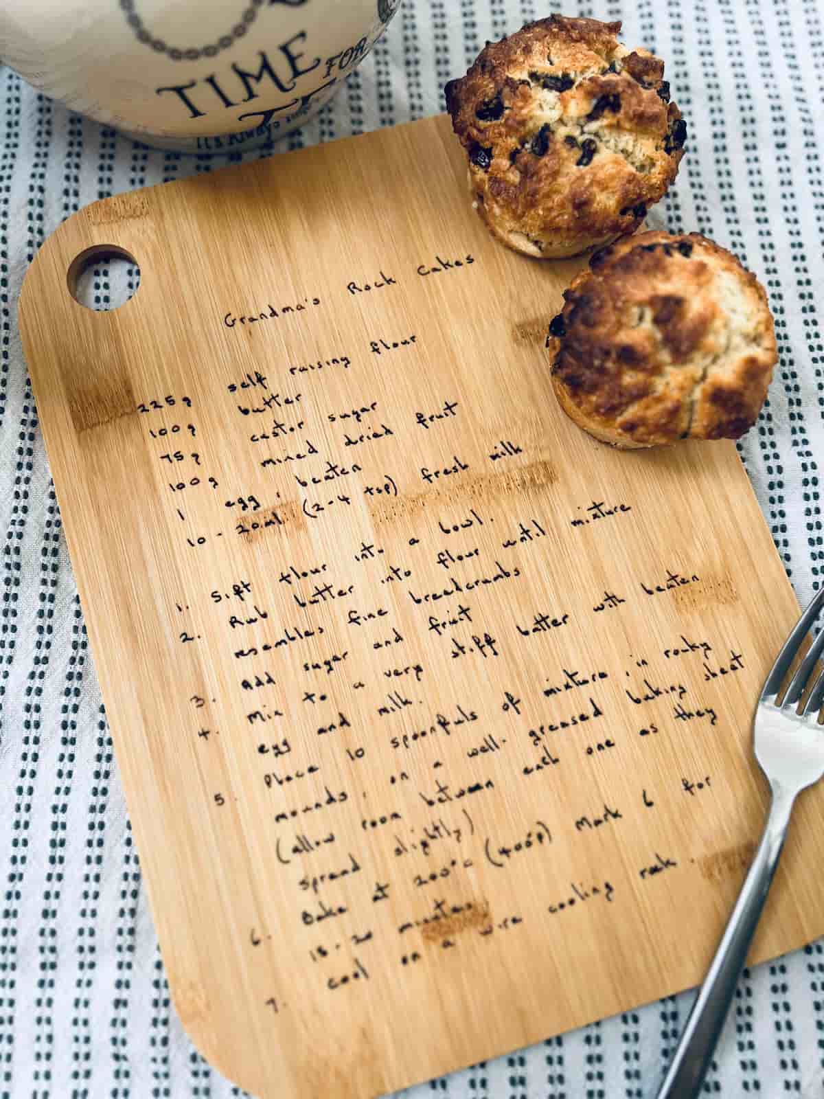A personalized wood engraved cutting board with a handwrittern recipe.