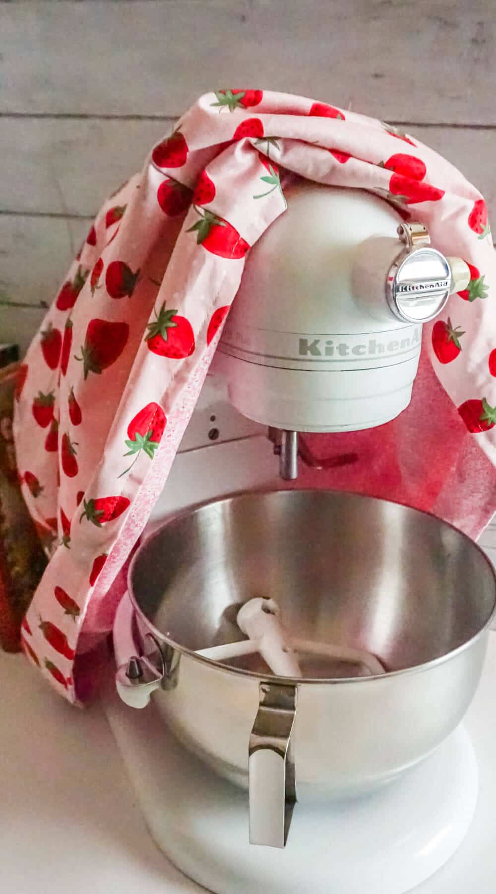 A homemade kitchen stand cloth cover with a strawvberry pattern.