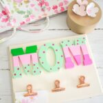 Mother's Day wall organizer craft on a white wood surface.