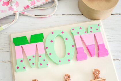 Mother's Day wall organizer craft on a white wood surface.
