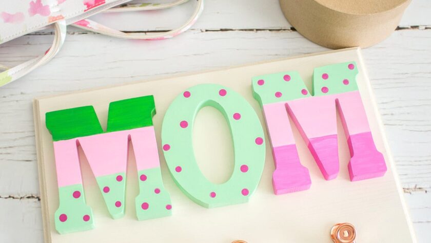 Mother's Day wall organizer craft on a white wood surface.