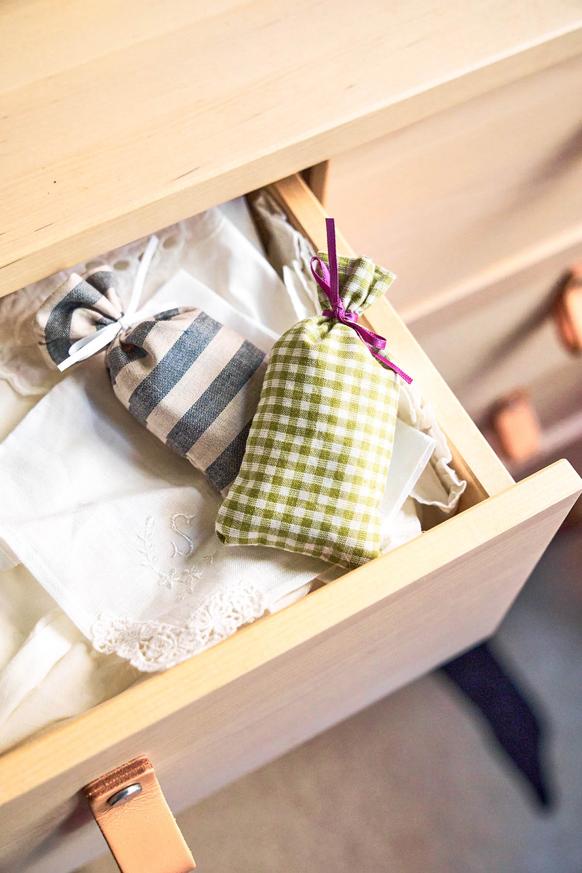 Lavender drawer sachets in an open dresser drawer.